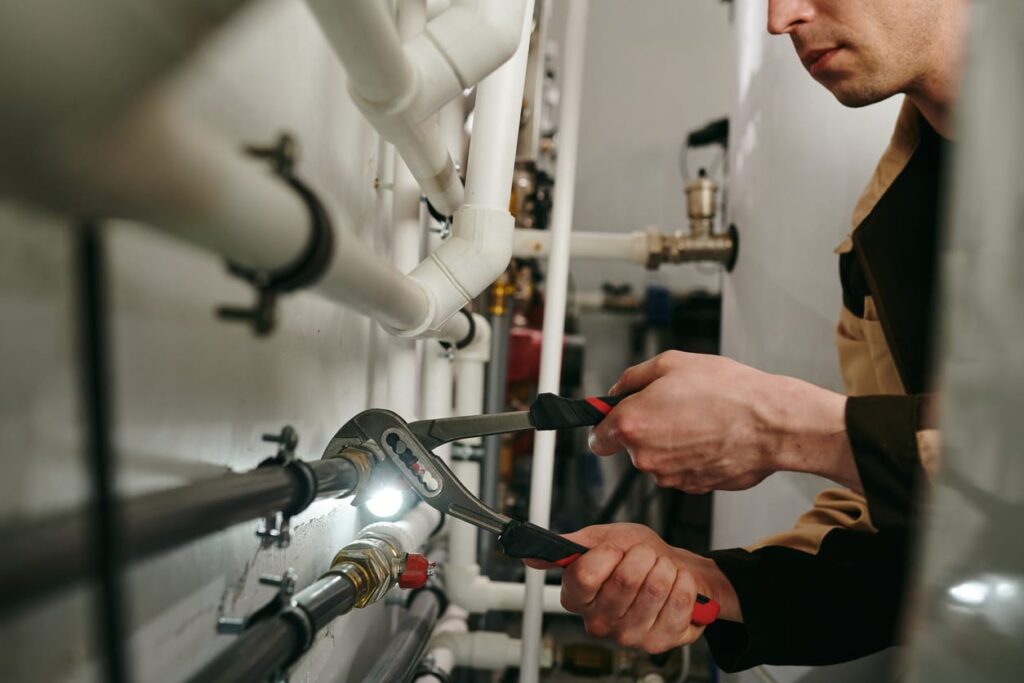 Plumbers maintaining commercial plumbing pipes in West Jordan