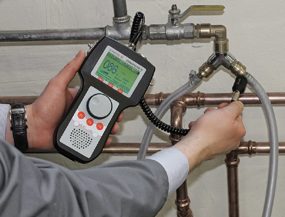 Plumber testing pipes with electronic leak detection equipment in West Jordan