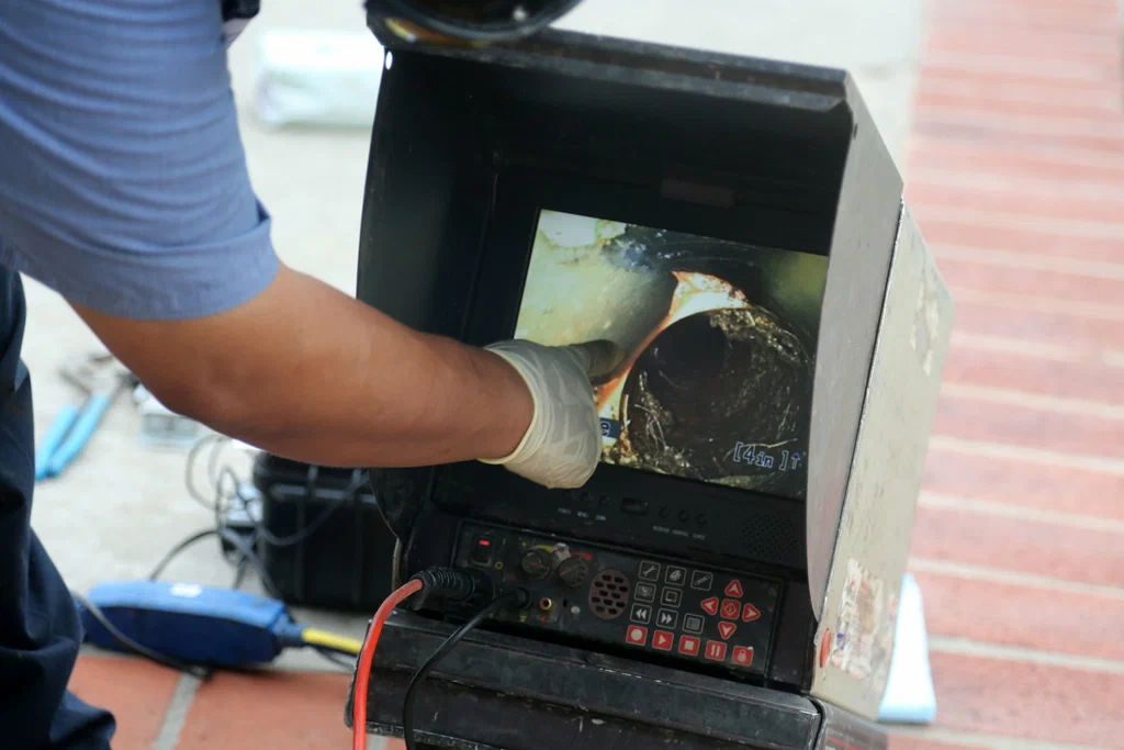 Technician viewing a drain inspection camera in West Jordan